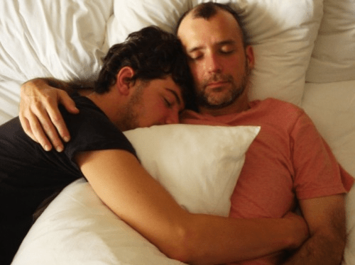 men in bed, cuddling