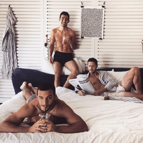 men drinking coffee in bed