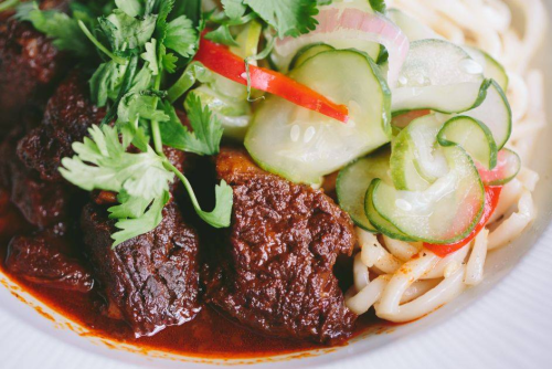Khar Saiko is boneless beef short ribs braised in tamarind, ginger, chili pods and soy that are served with garlic fresh Shanghai noodles (it is like a garlicky linguine) and pickled cucumber