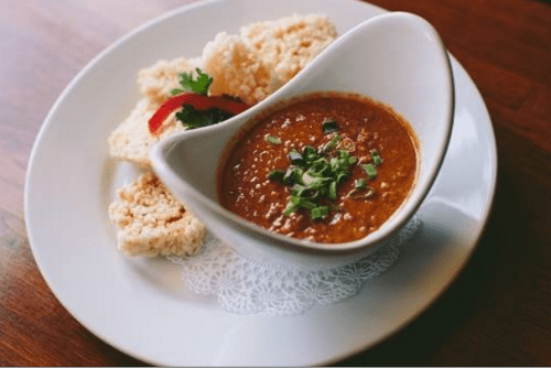 Nataing is a delicious appetizer made with Ground pork simmered in coconut milk with garlic, peanuts and served with crispy rice