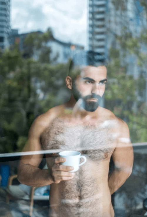 shirtless guy looking out a window, pensive, sexy man, hairy man, hairy chest