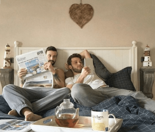 Men in bed together