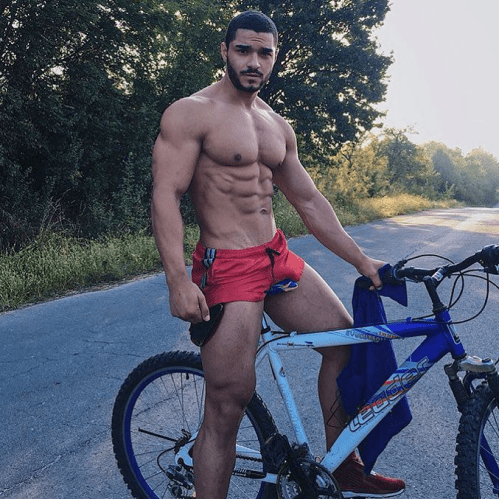 shirtless handsome guy on a bike, red shorts, hunk