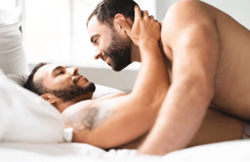 handsome couple in bed cuddling